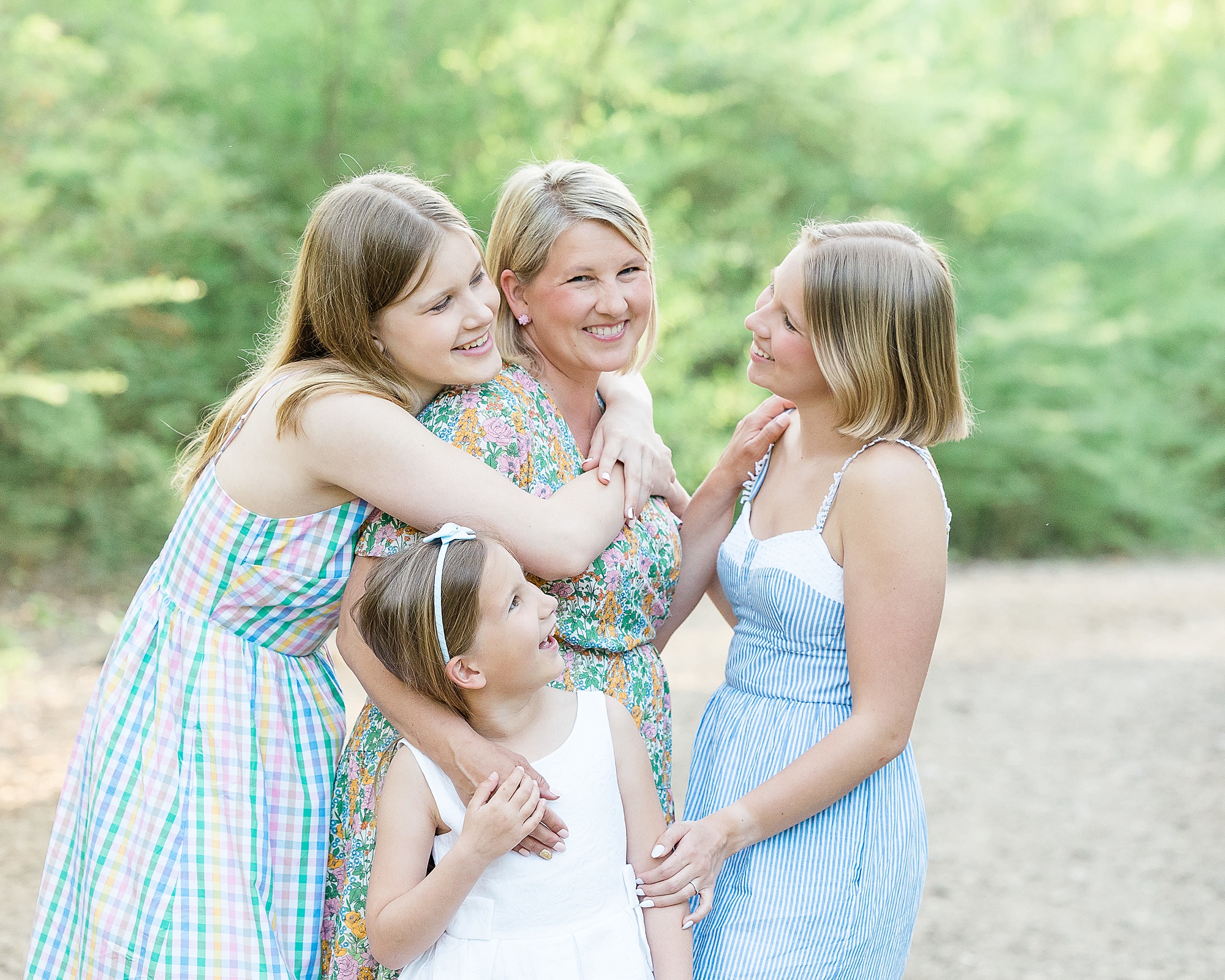 mom laughs with daughters during family photos at Clear Creek Natural Heritage Center
