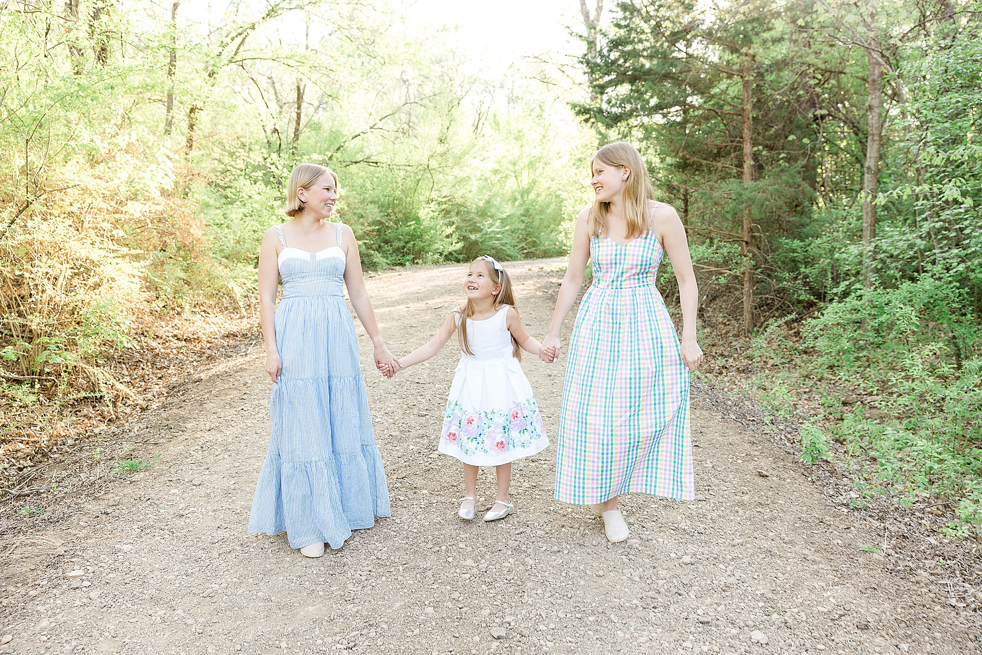 sisters hold hands during family photos in Texas