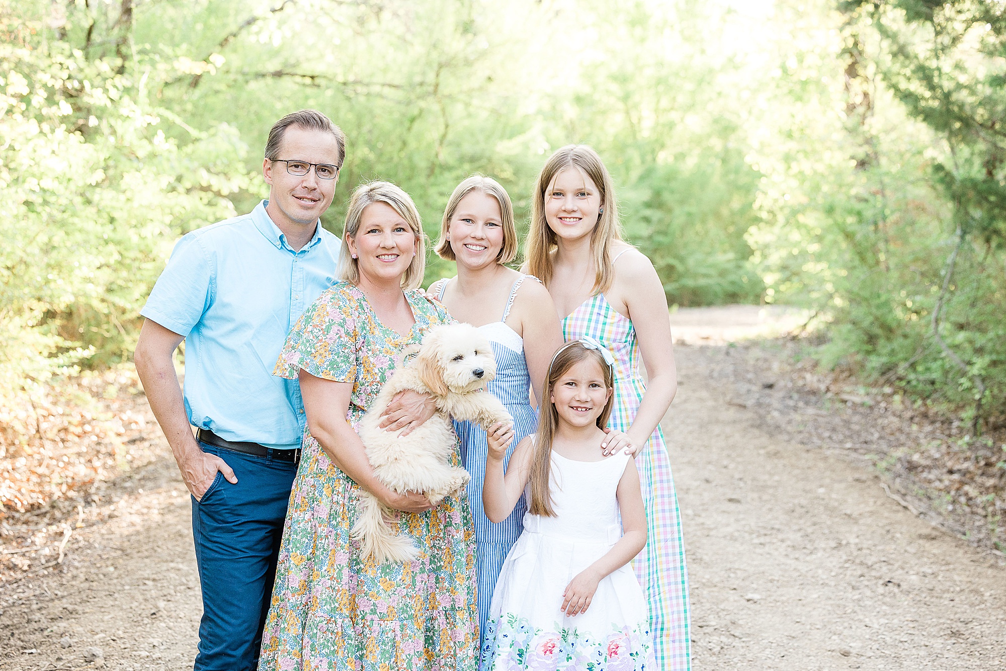 family of five poses with dog during portraits in Texas