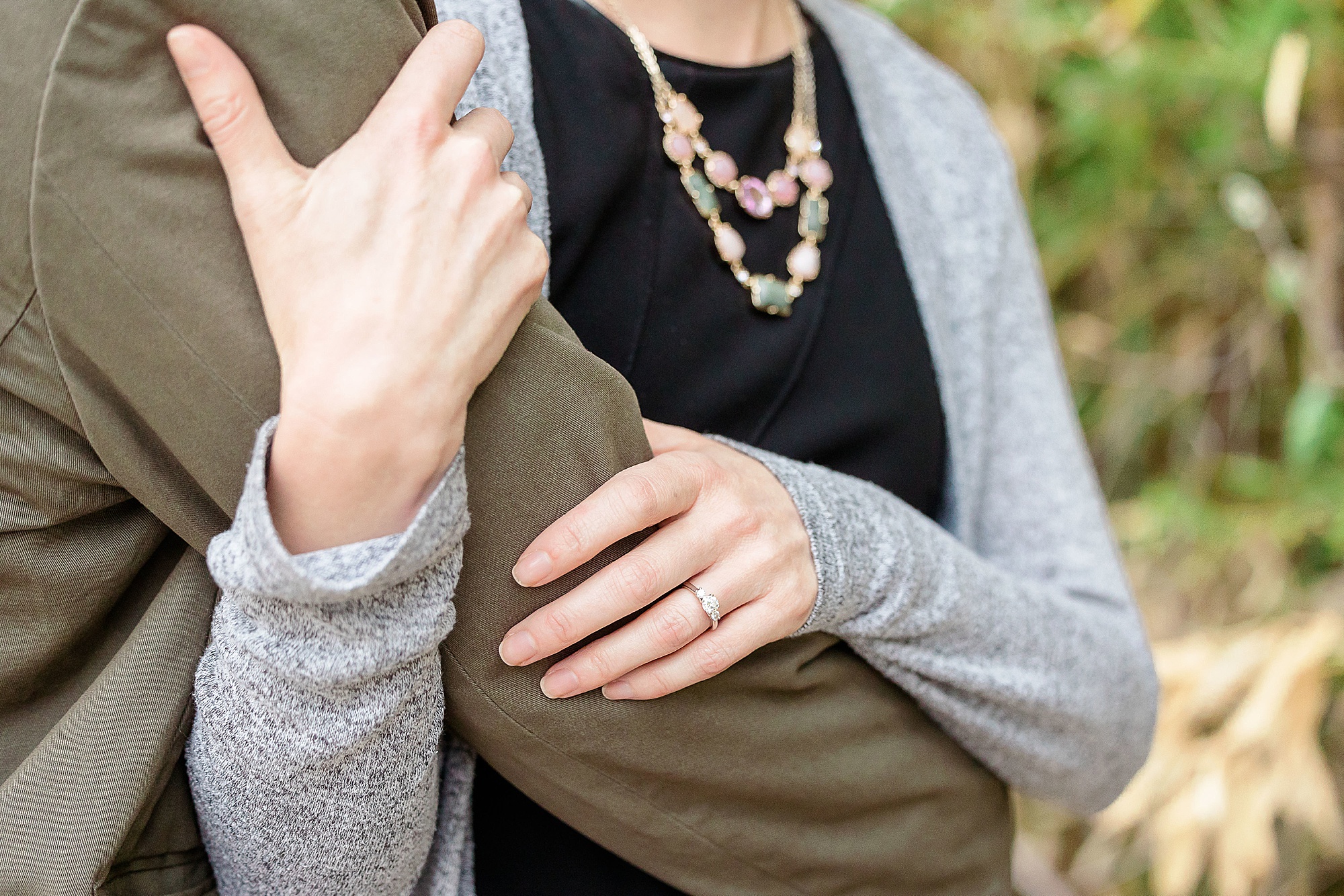 woman holds fiancé's arm during Katy Trail engagement session