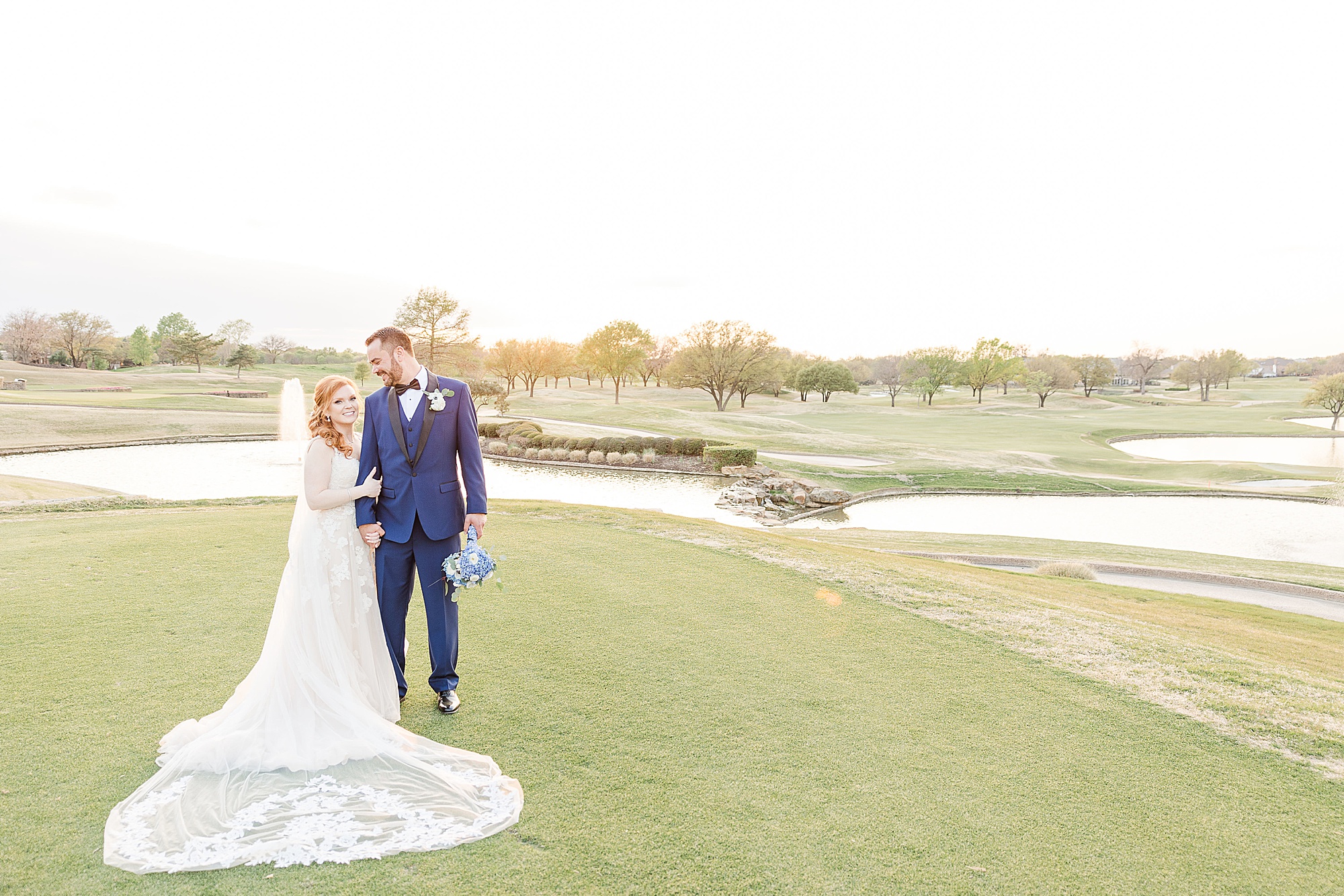 bride and groom pose on golf course at Stonebriar Country Club