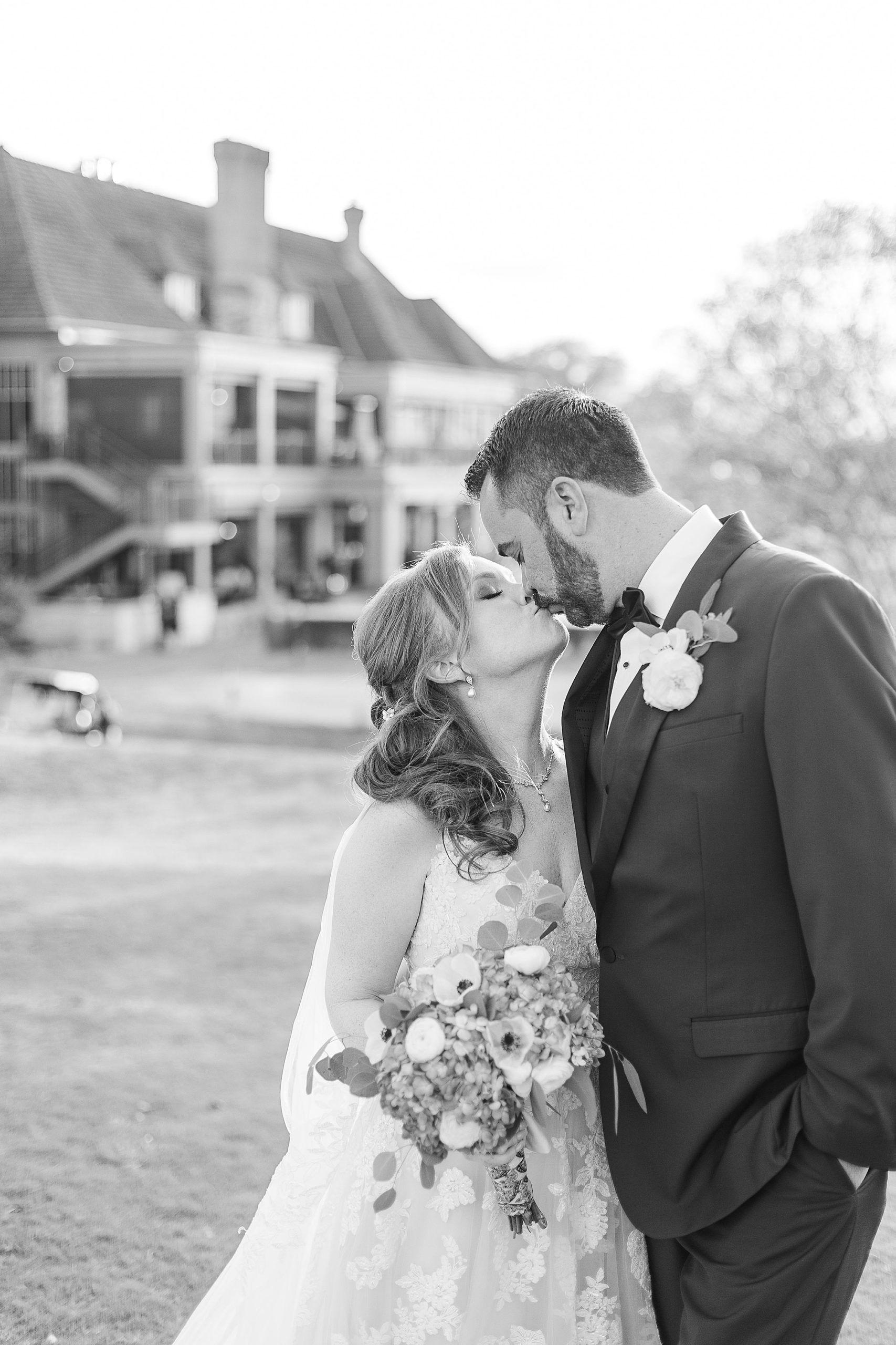 bride and groom kiss outside Stonebriar Country Club