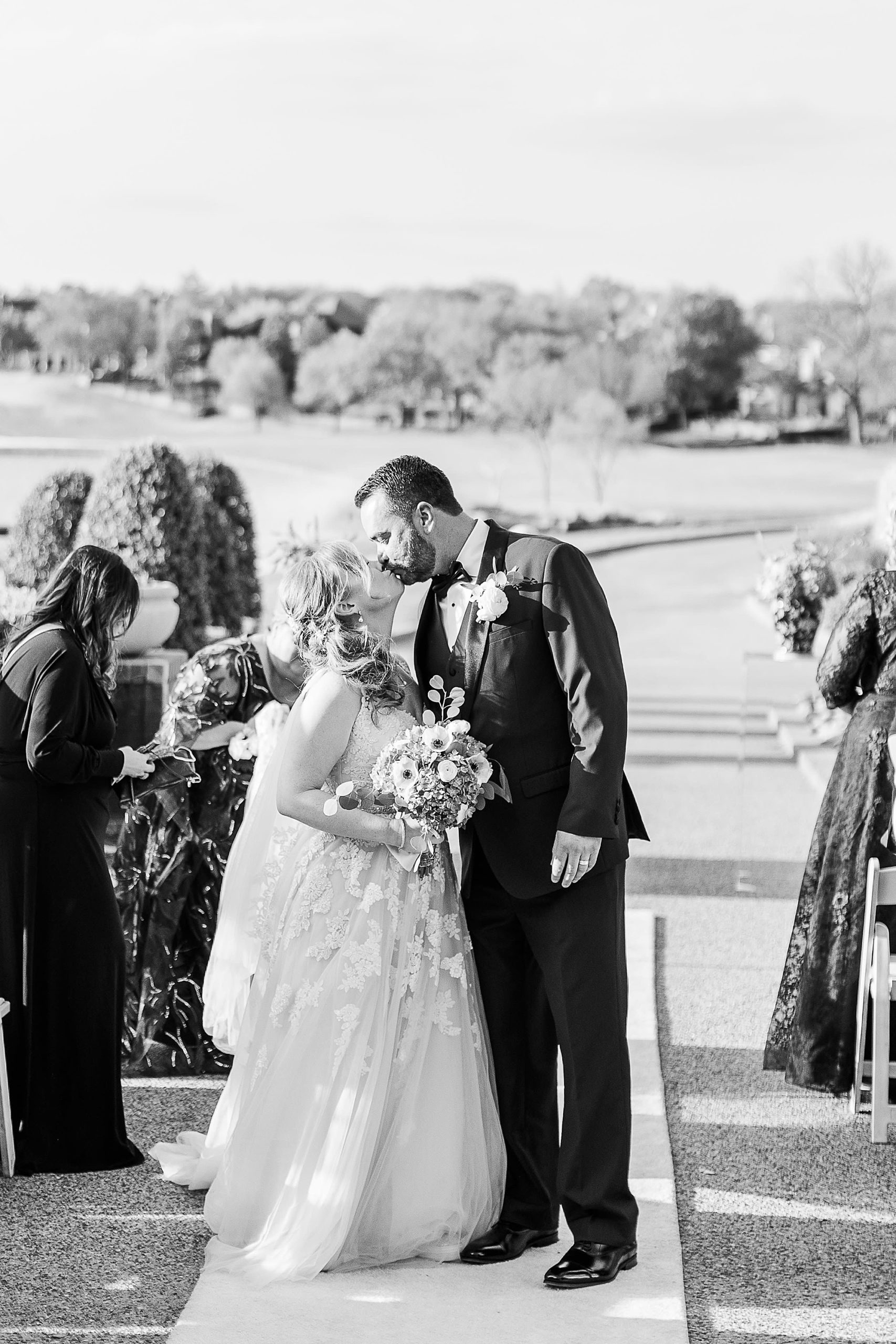 couple kisses after Stonebriar Country Club wedding ceremony