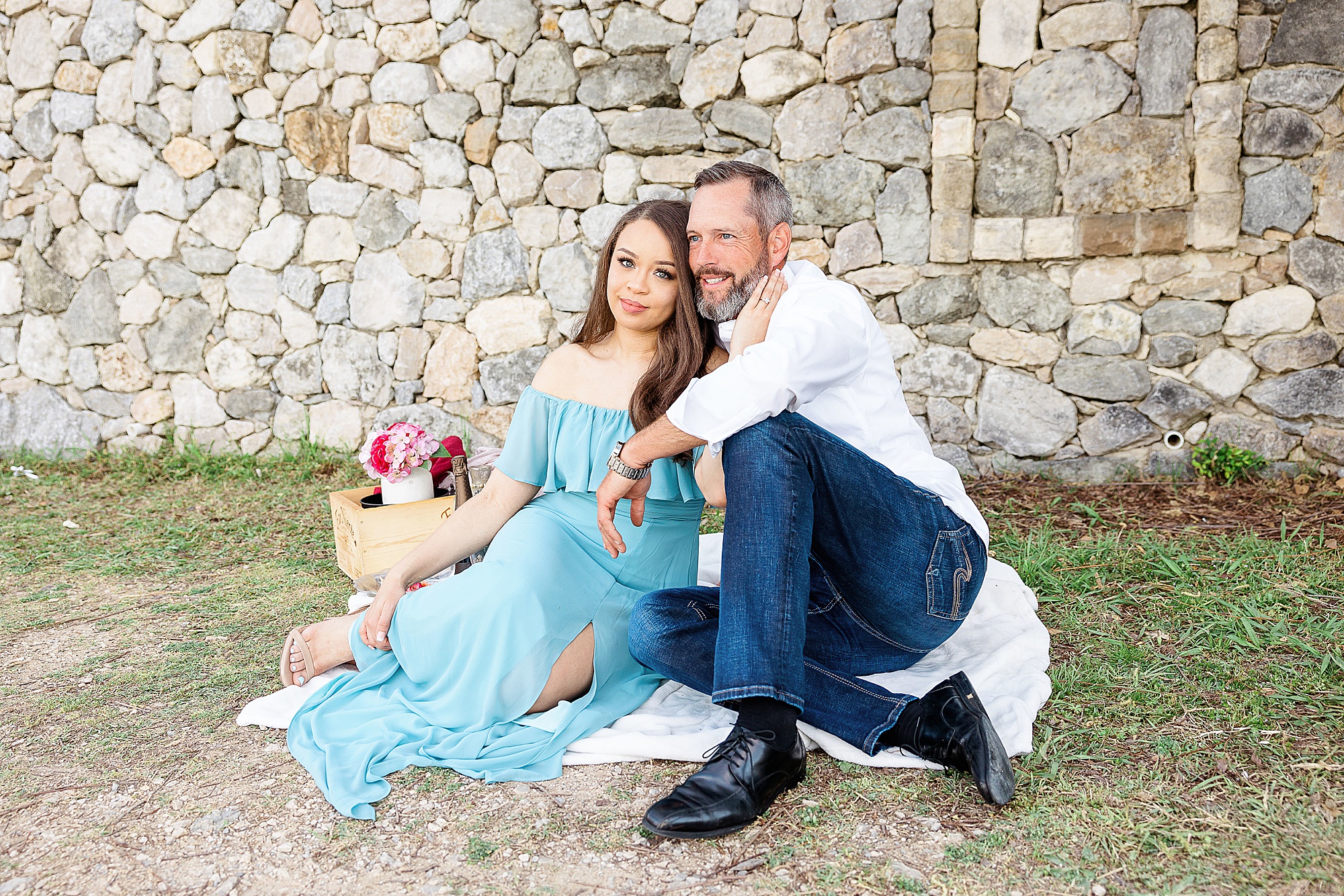 bride and groom enjoy picnic during engagement session in Texas