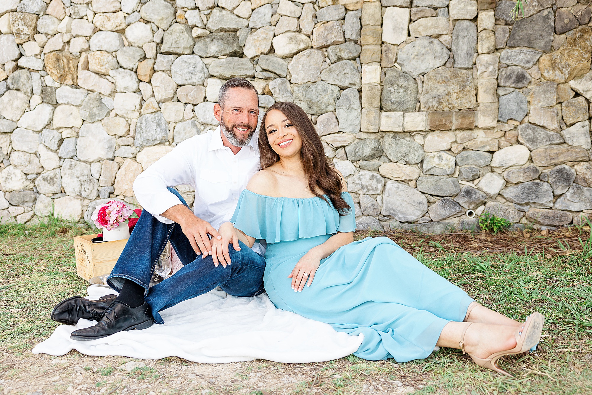 engaged couple poses together during picnic for Adriatica Village engagement session 