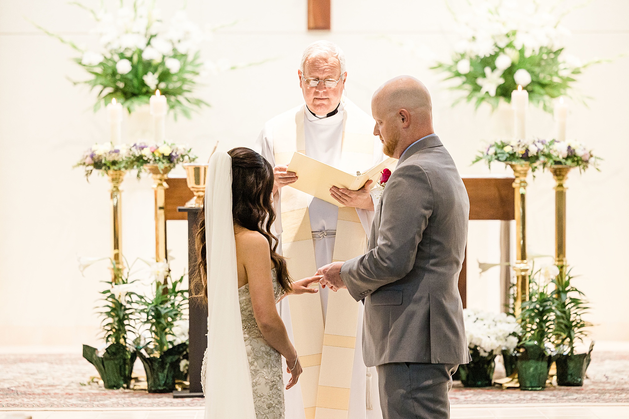 groom puts ring on bride's hand during St. Elizabeth Ann Seton Formation Center Vow Renewal