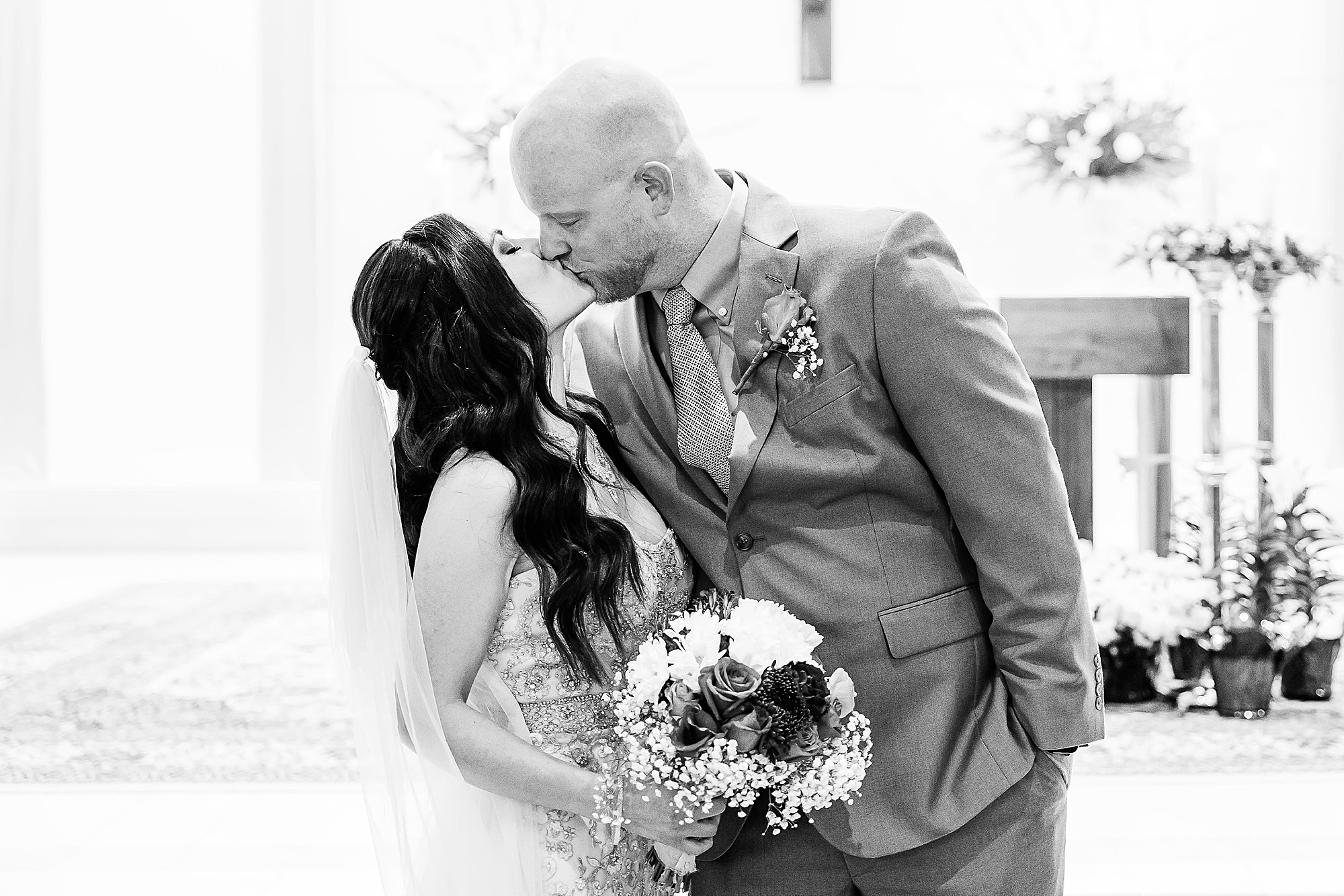 newlyweds kiss during Plano TX wedding day 