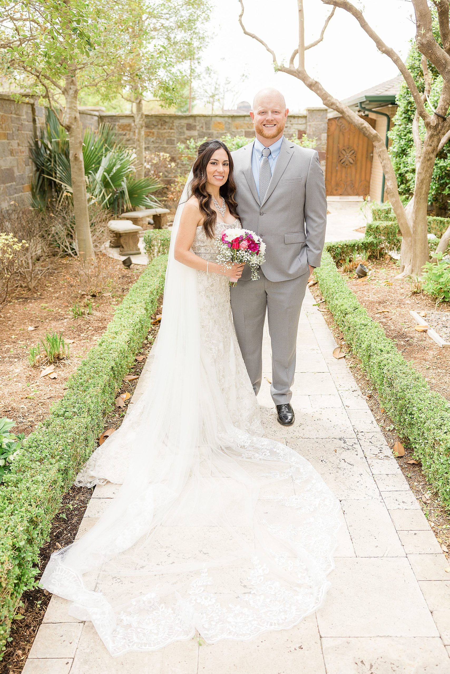 Texas bride and groom pose in church garden