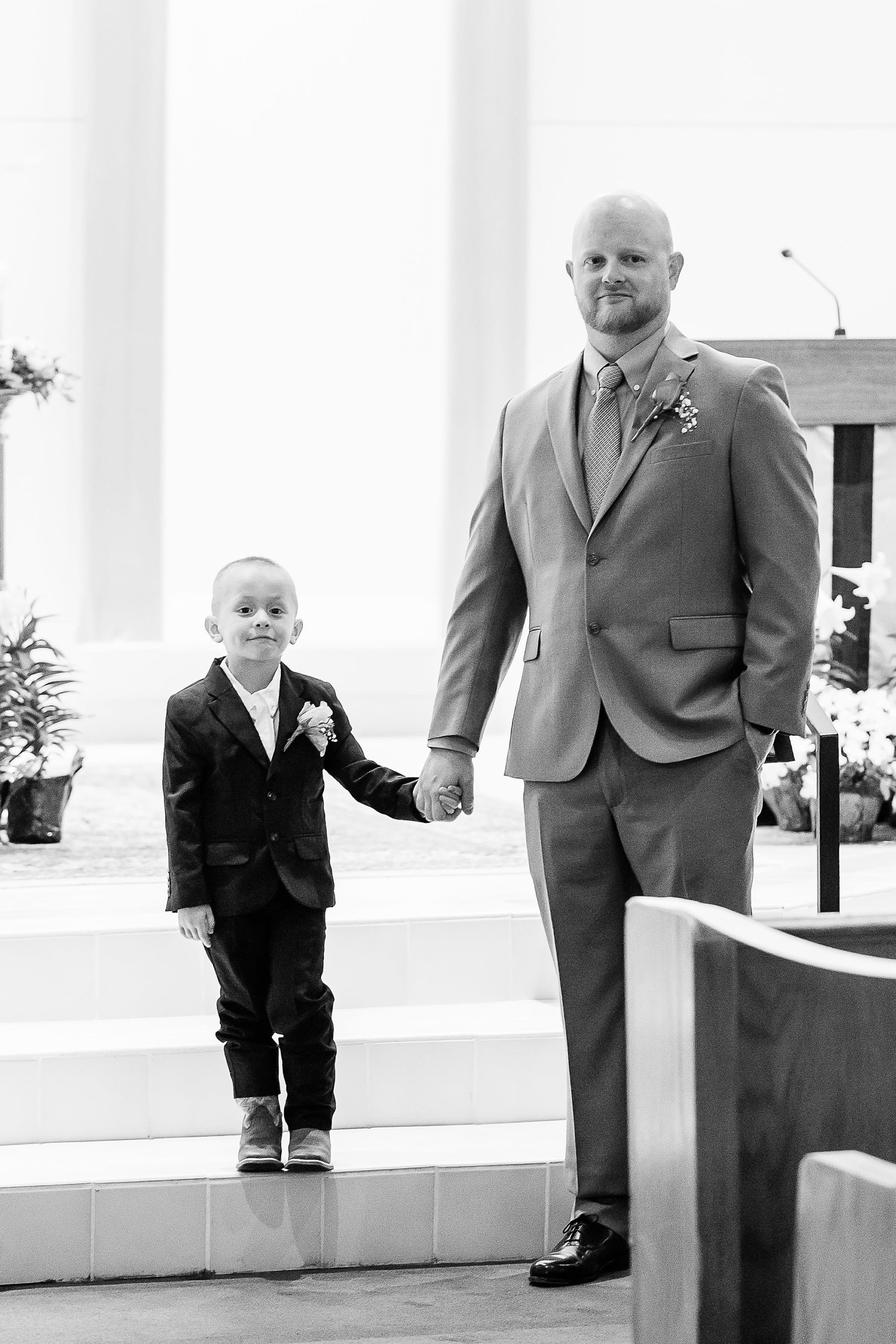 dad holds son's and during wedding ceremony 