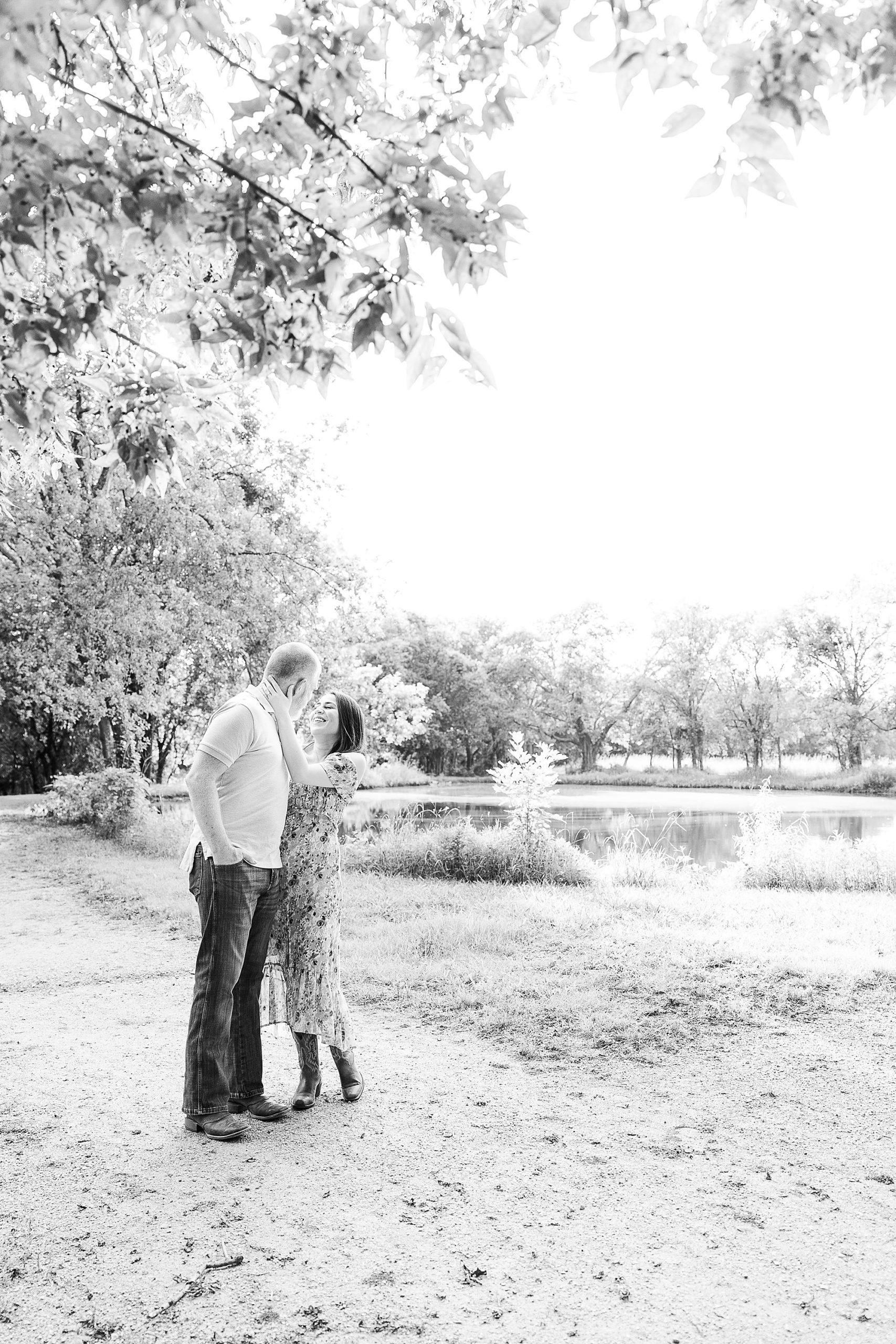 bride and groom pose by pond in Parker Rose Garden