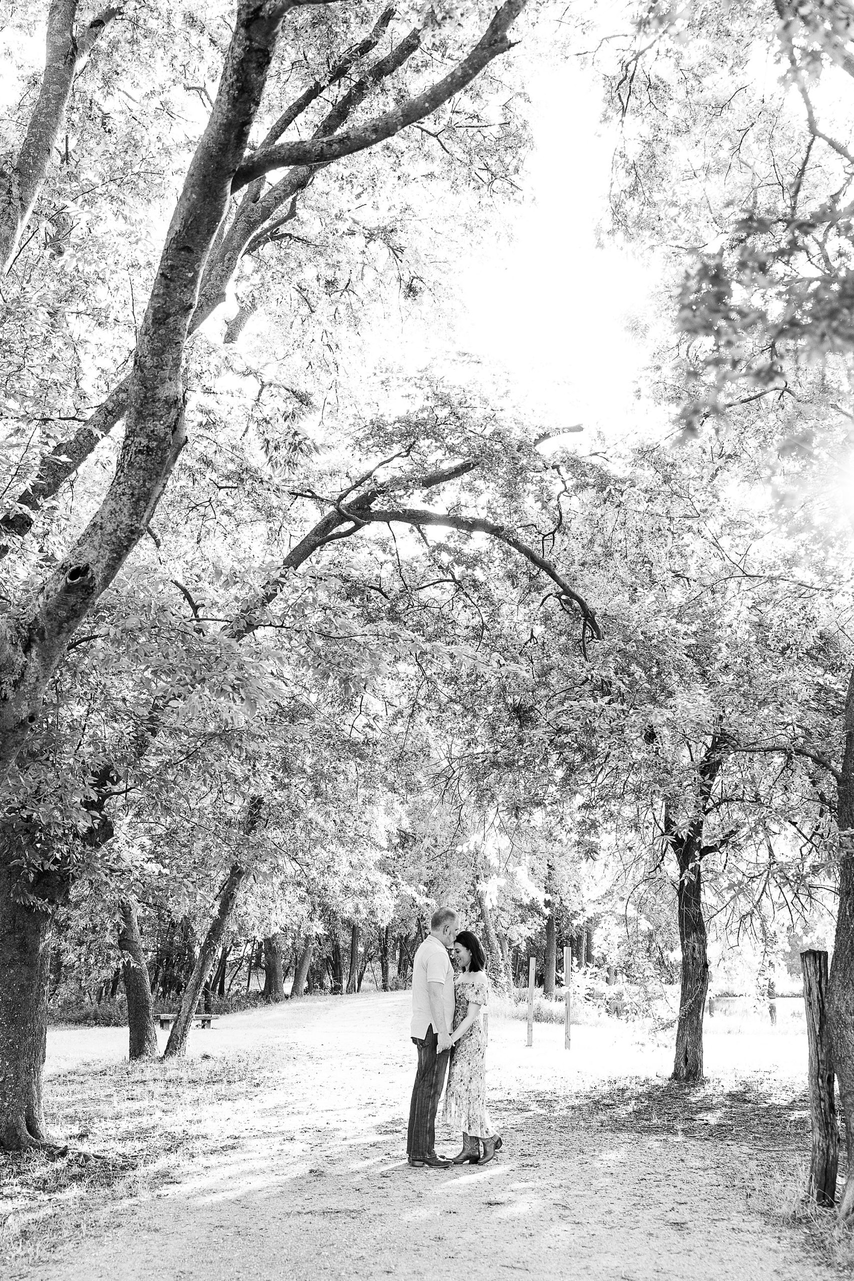 bride and groom pose on pathway in Parker Rose Garden