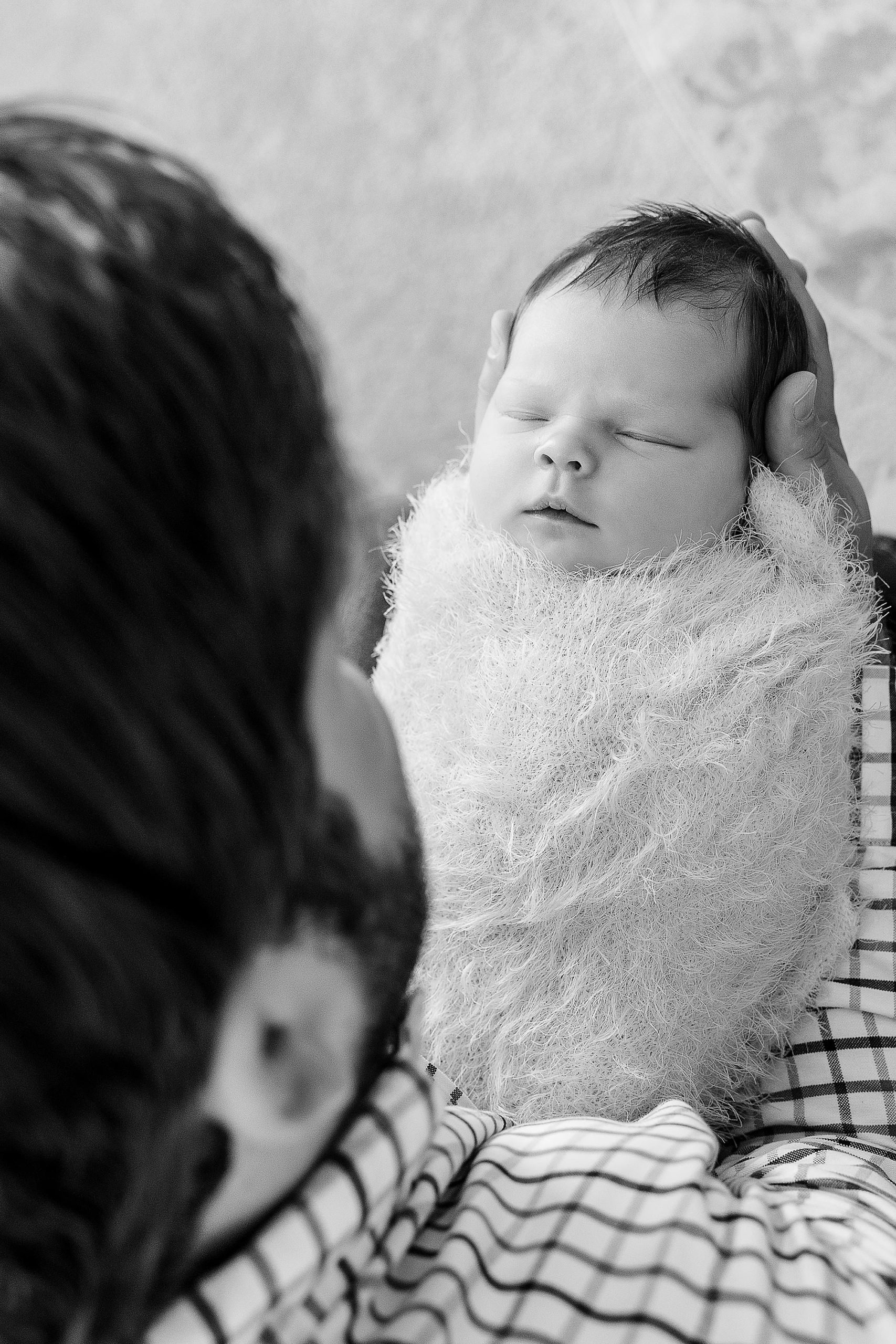 dad looks at baby girl during Krum TX lifestyle newborn session