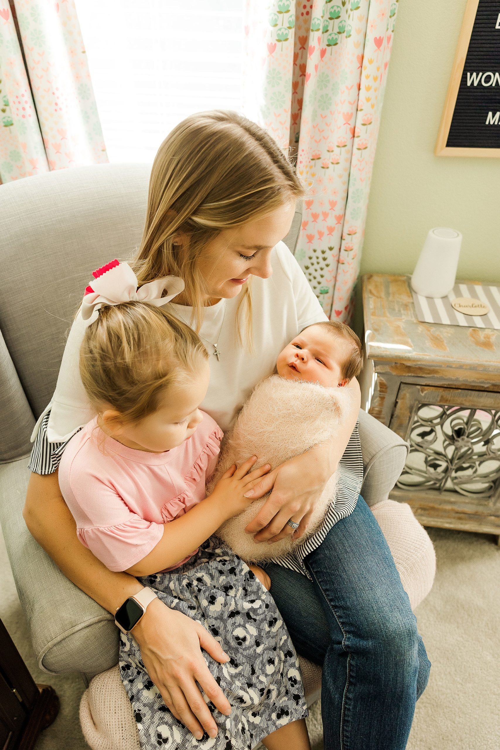 mom rocks daughters during Krum lifestyle newborn session