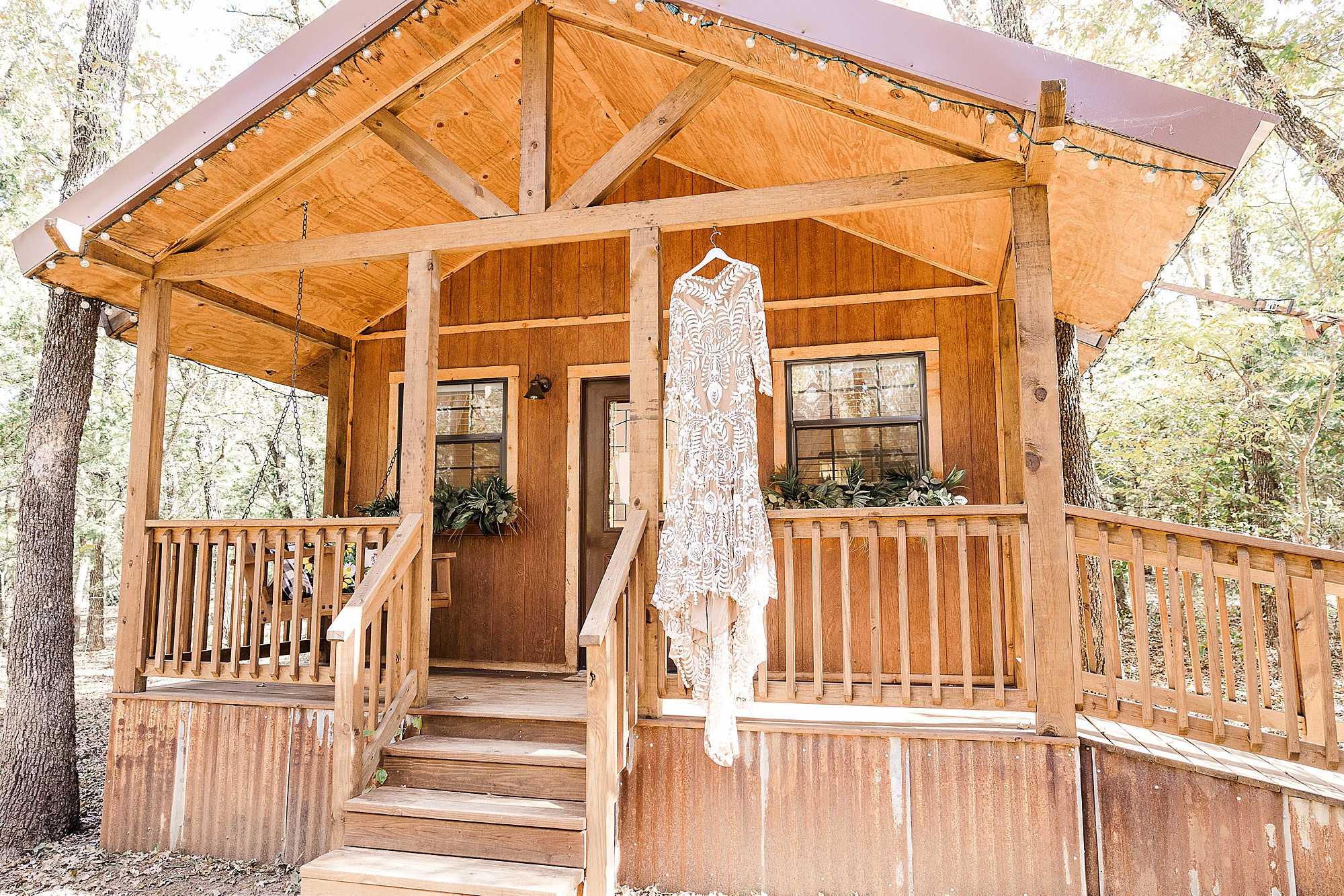 wedding dress hangs on cabin at Oak Meadow Ranch