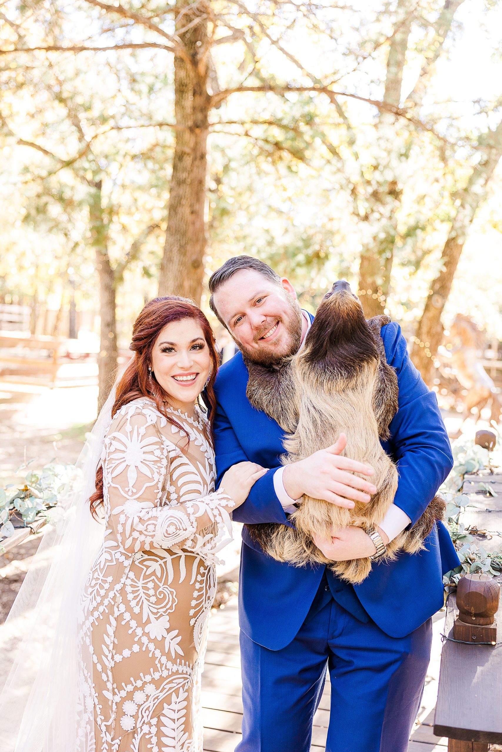 couple meets sloth at Oak Meadow Ranch on wedding day