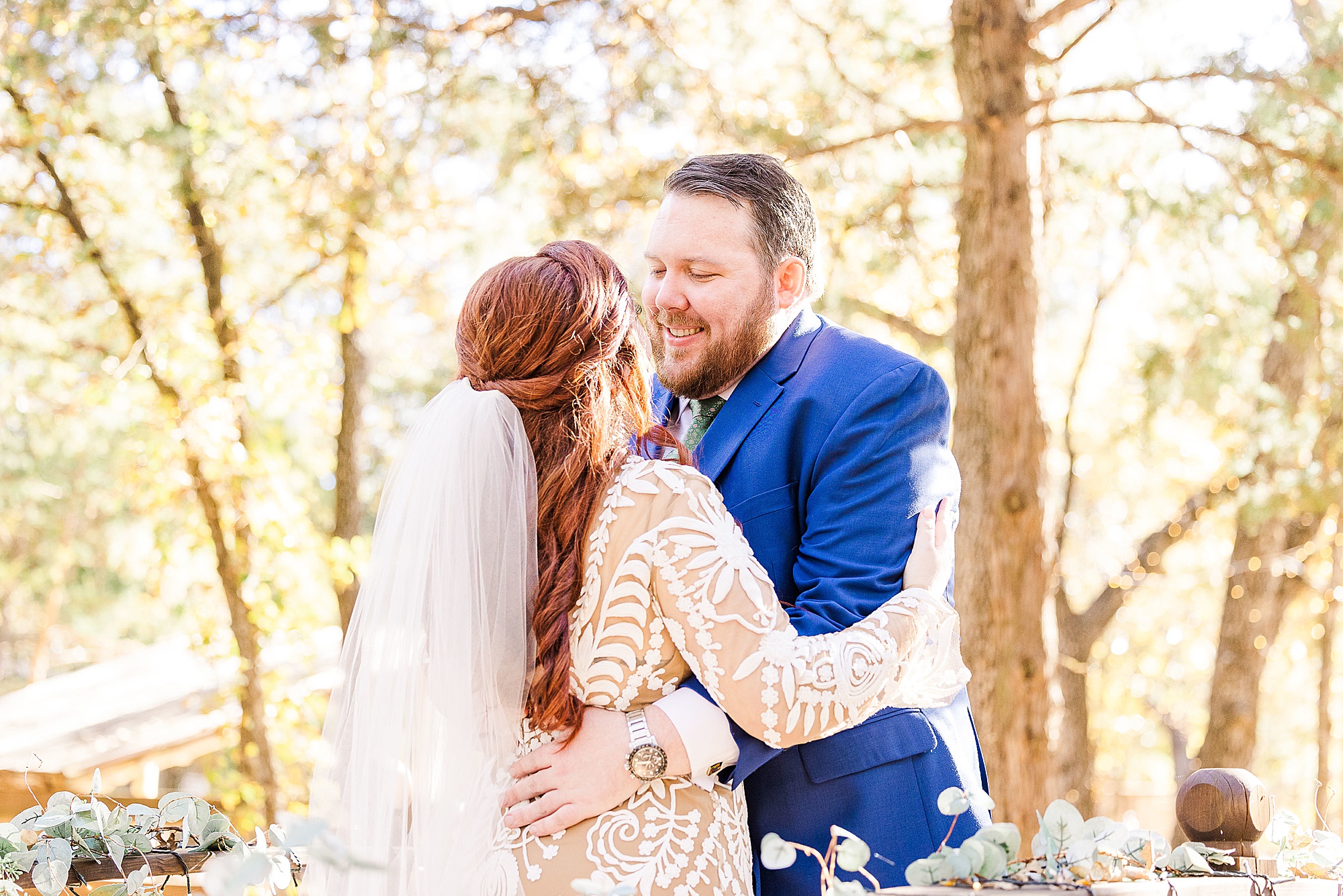 newlyweds hug during Texas first look in woods 
