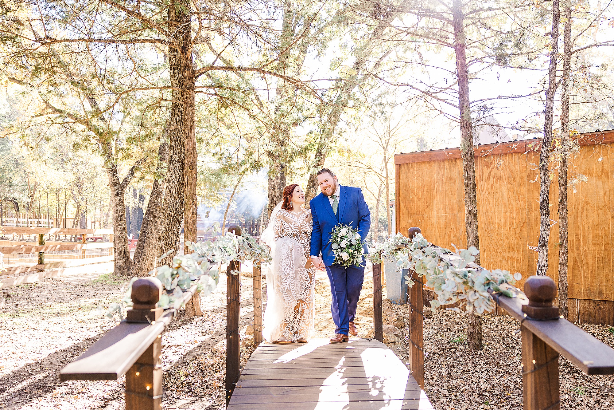 bride and groom walk over bridge at Oak Meadow Ranch