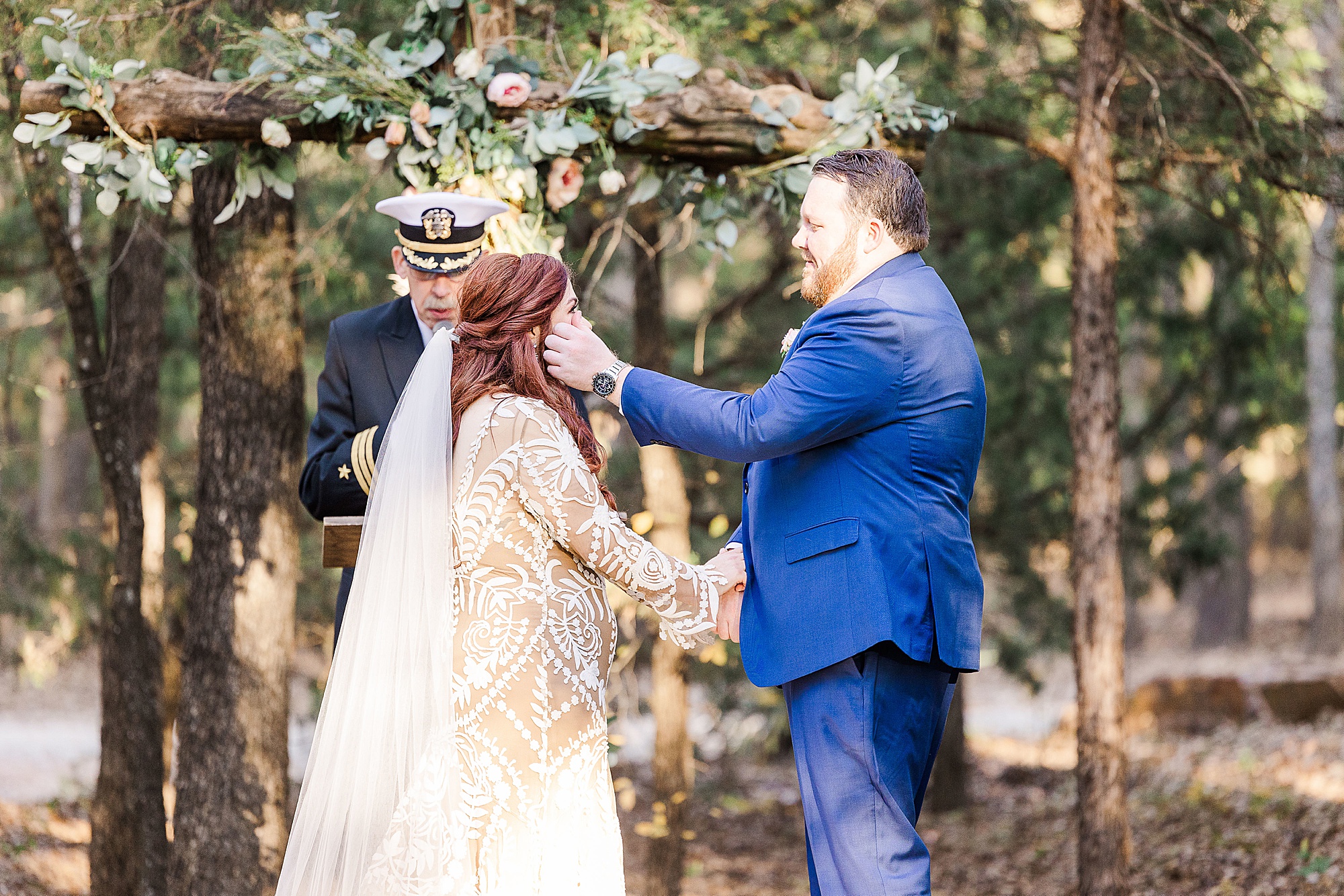 groom wipes bride's tears during outdoor wedding ceremony in Texas