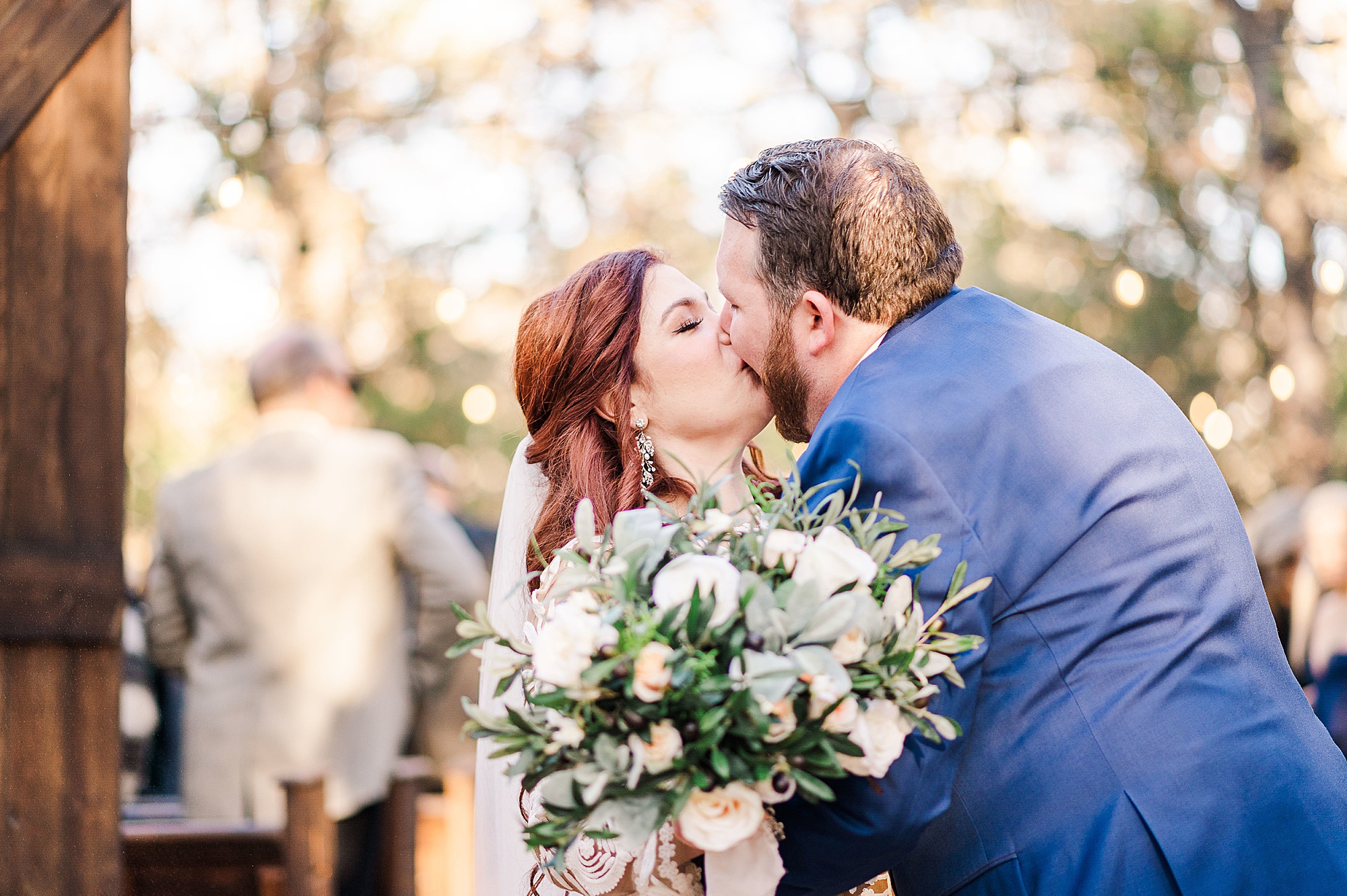 bride and groom kiss after outdoor wedding ceremony in Texas