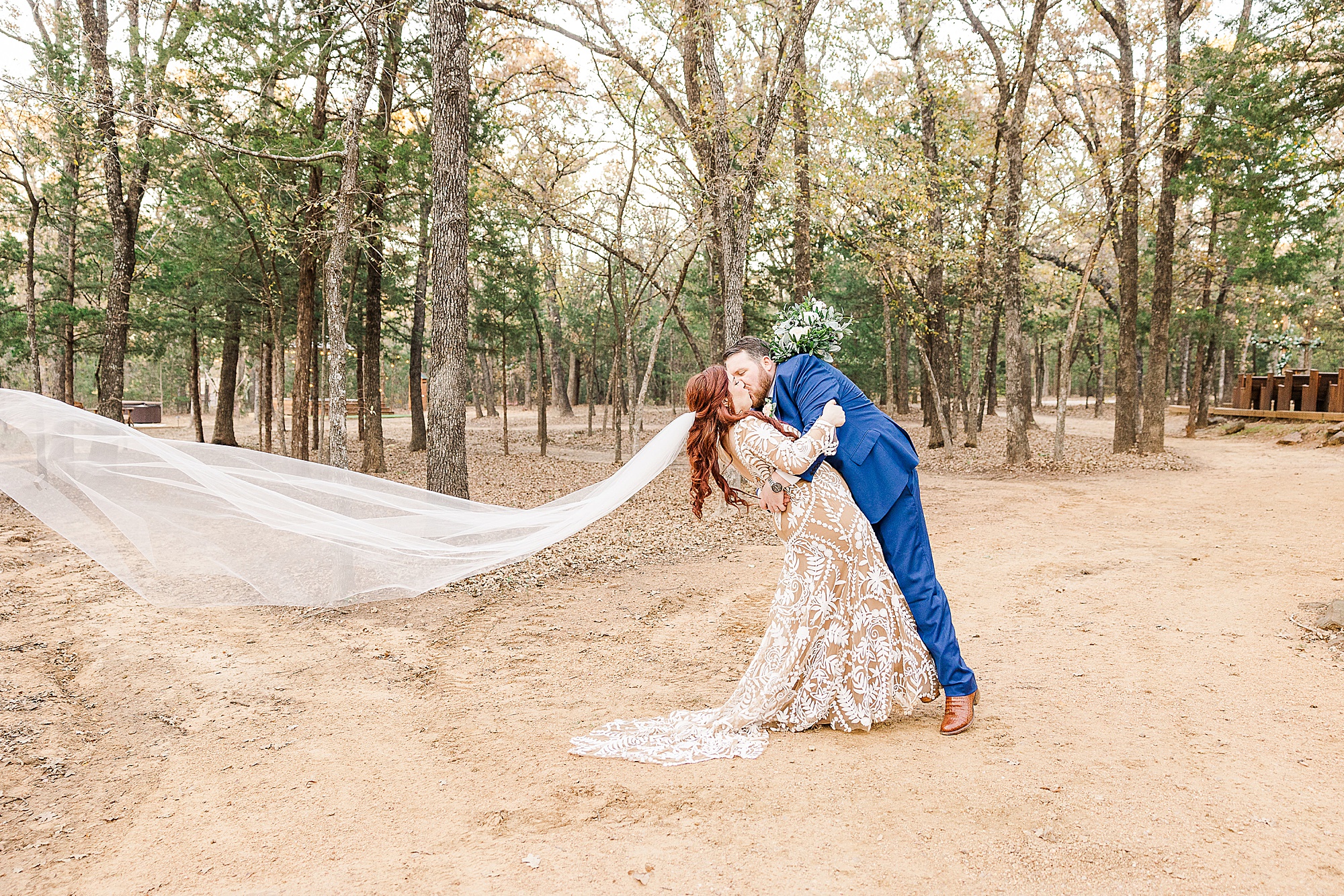 groom kisses bride during Oak Meadow Ranch wedding portraits 