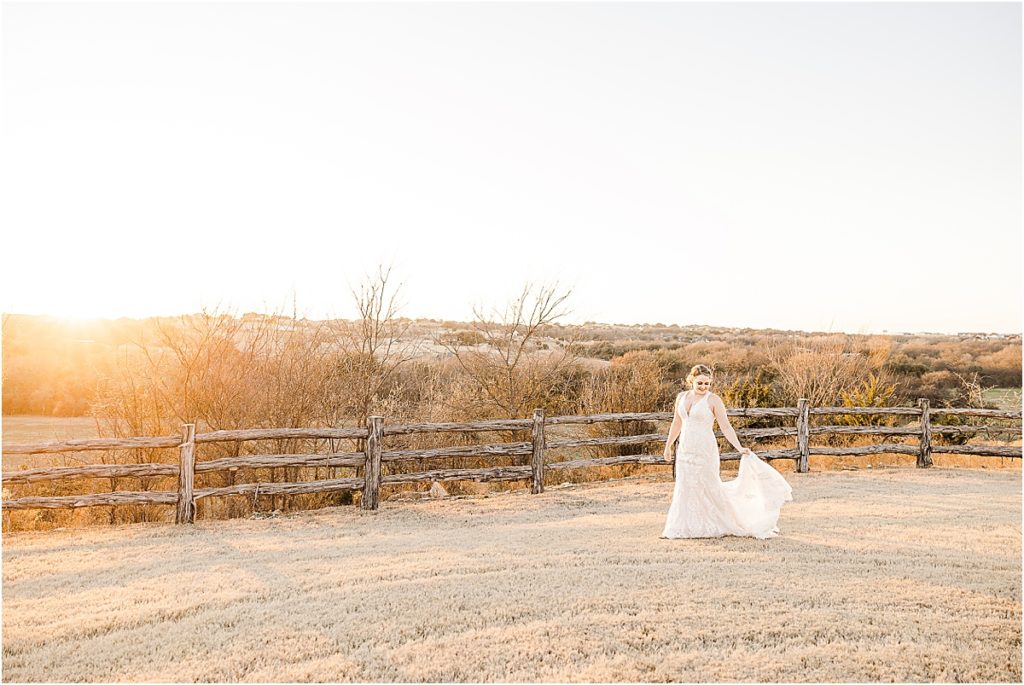 bride walking in front of fence with sunset in background for stand-alone bridal session